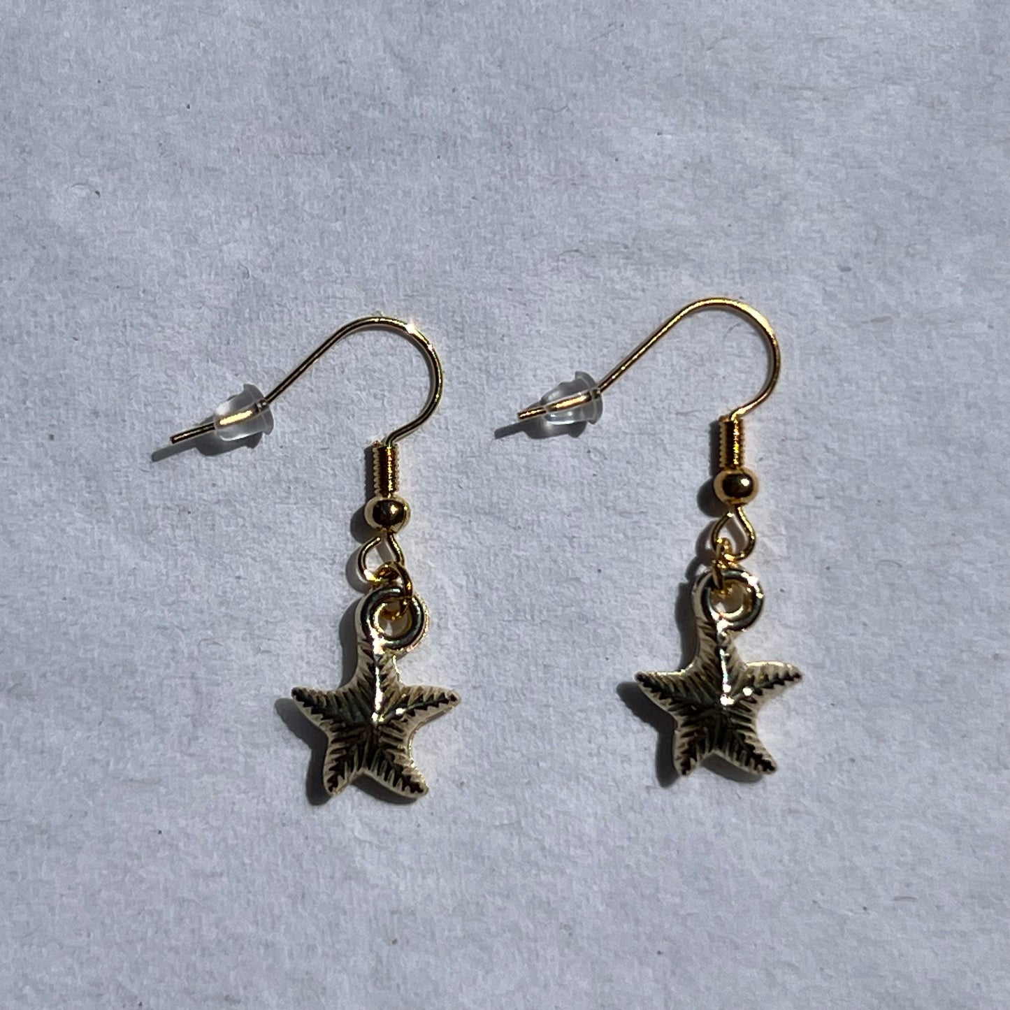 gold earrnings with a gold star