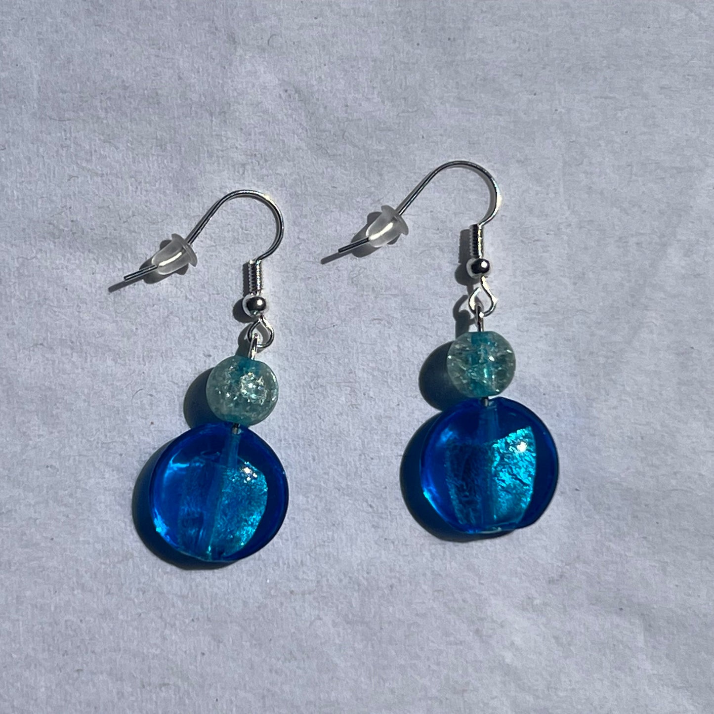 silver earnings with clear and blue beads