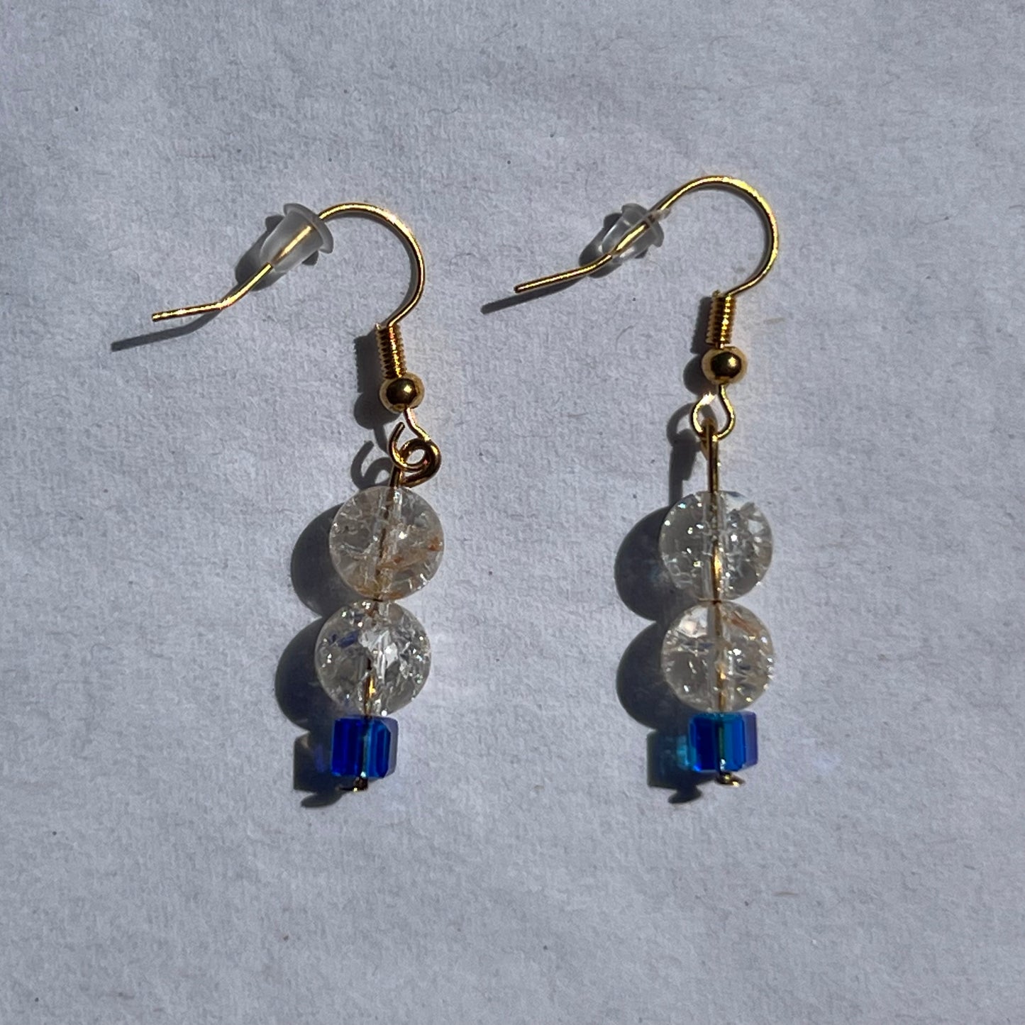 gold earnings with clear and blue beads