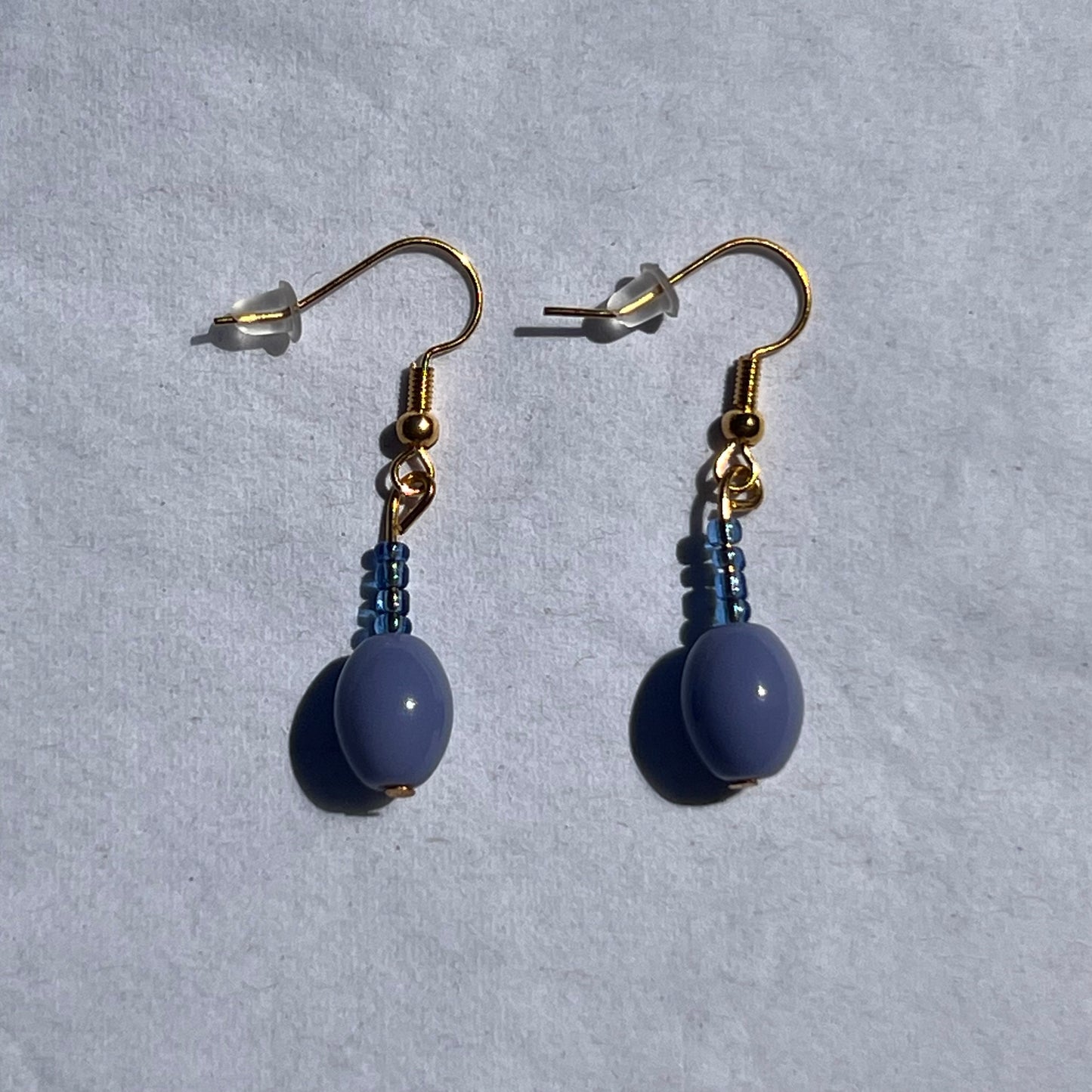 gold earrings with blue and purple beads