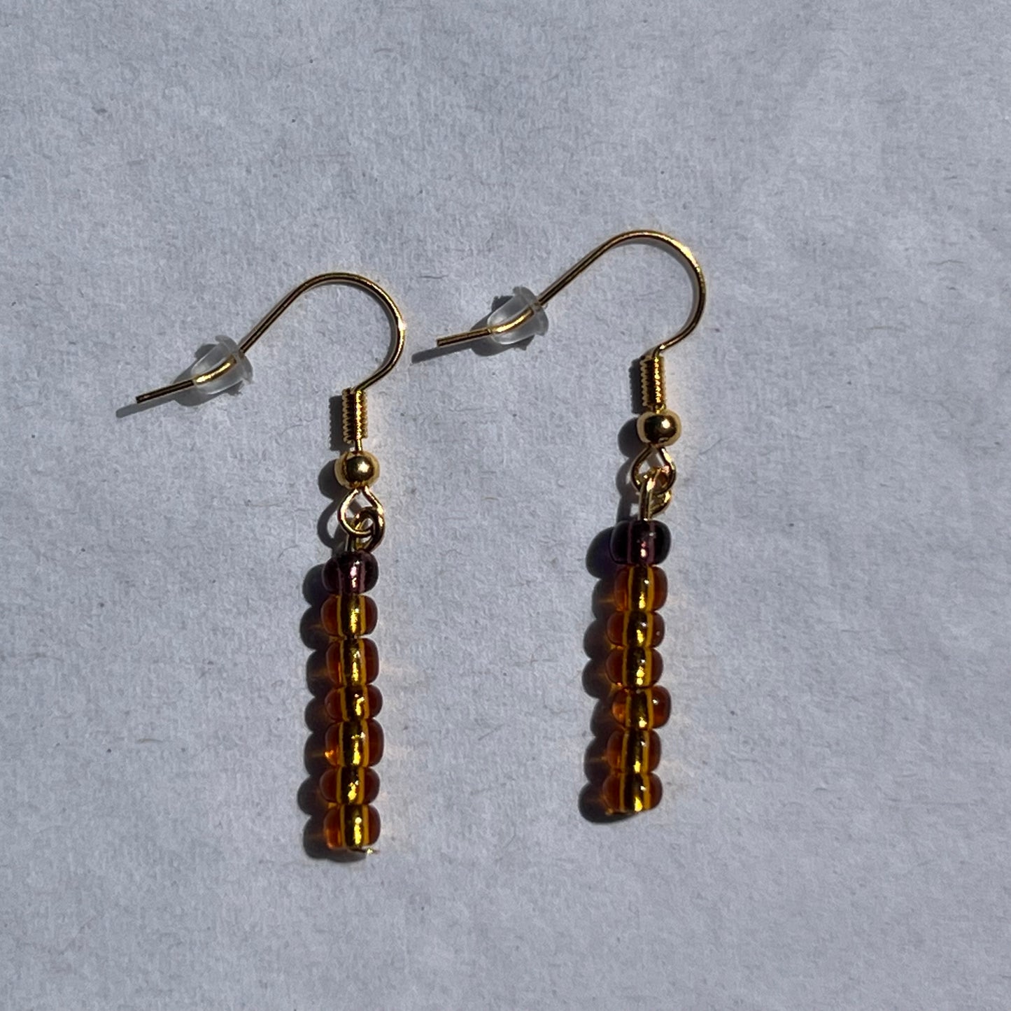 gold earnings with orange and brown beads