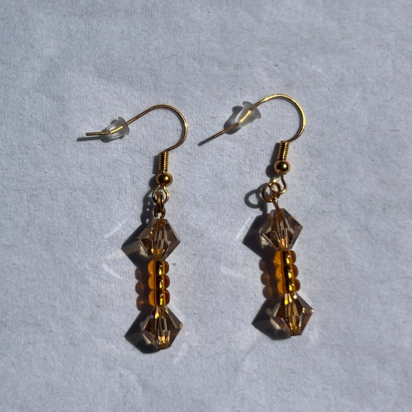 gold earnings with orange beads